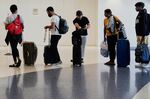 Travelers wait to check in for their flights at Los Angeles International Airport in Los Angeles, California, on July 1.