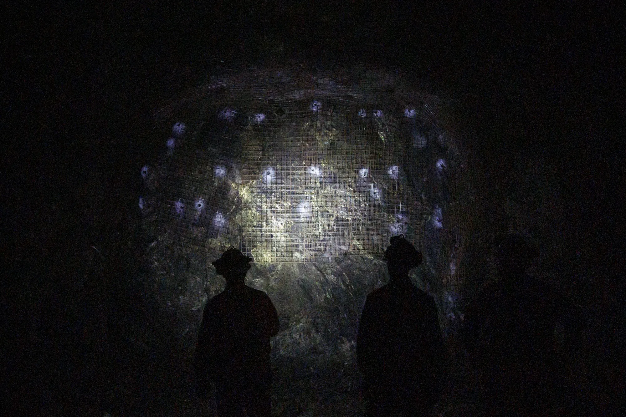 Workers inspect a wall containing minerals and metals at the Vale Copper Cliff mine in Sudbury, Ontario, Canada.