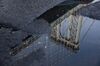 The Manhattan Bridge is reflected in a puddle on John Street in the Brooklyn borough of New York, U.S., on Friday, Sept. 20, 2019. Slumping tech stocks dragged down U.S. indexes as traders moved on from a busy week for central bank meetings to shift their focus back to the trade war and geopolitical tensions.