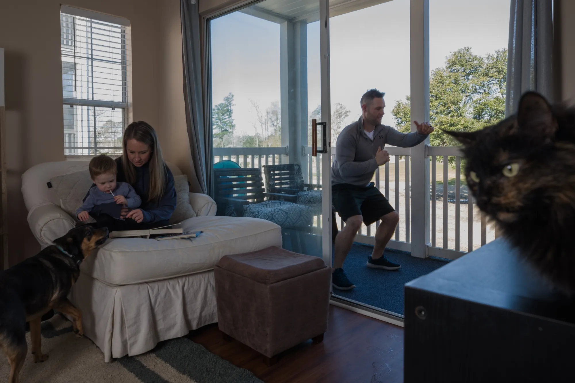 Mike Tilberry leads a Zoom workout on the deck near his wife and child at home in Myrtle Beach, South Carolina, on Feb.20.