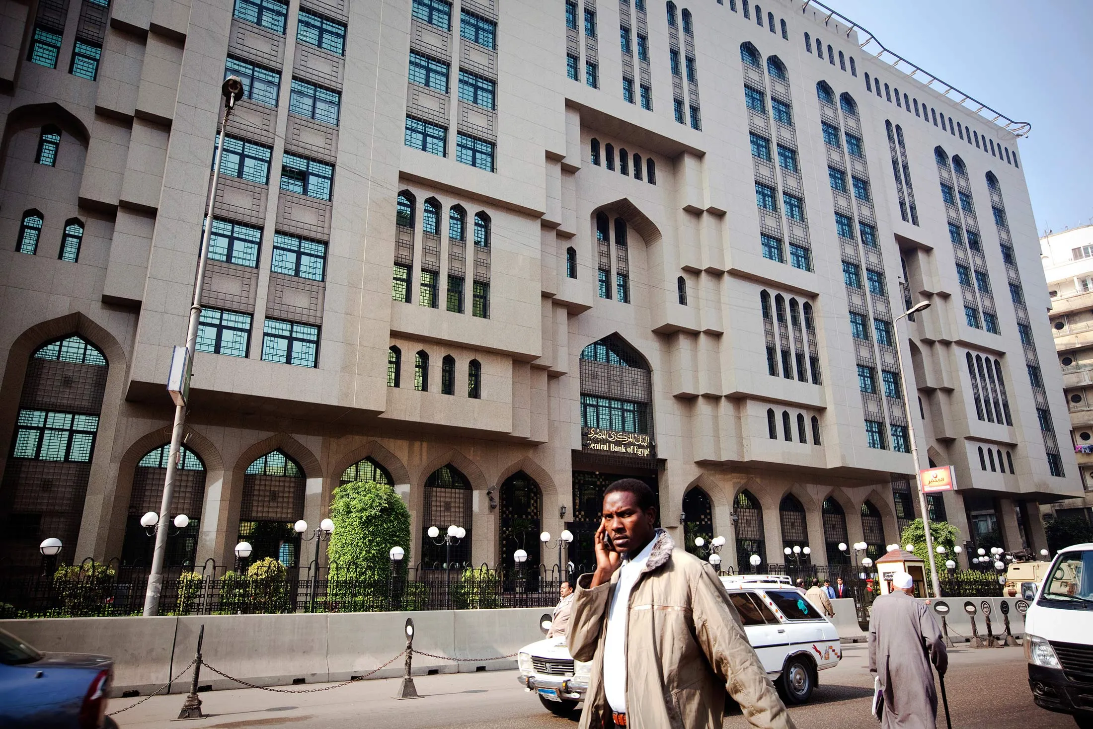 A man makes his way past the Central Bank of Egypt in Cairo, Egypt, Tuesday, Nov. 22, 2011.

