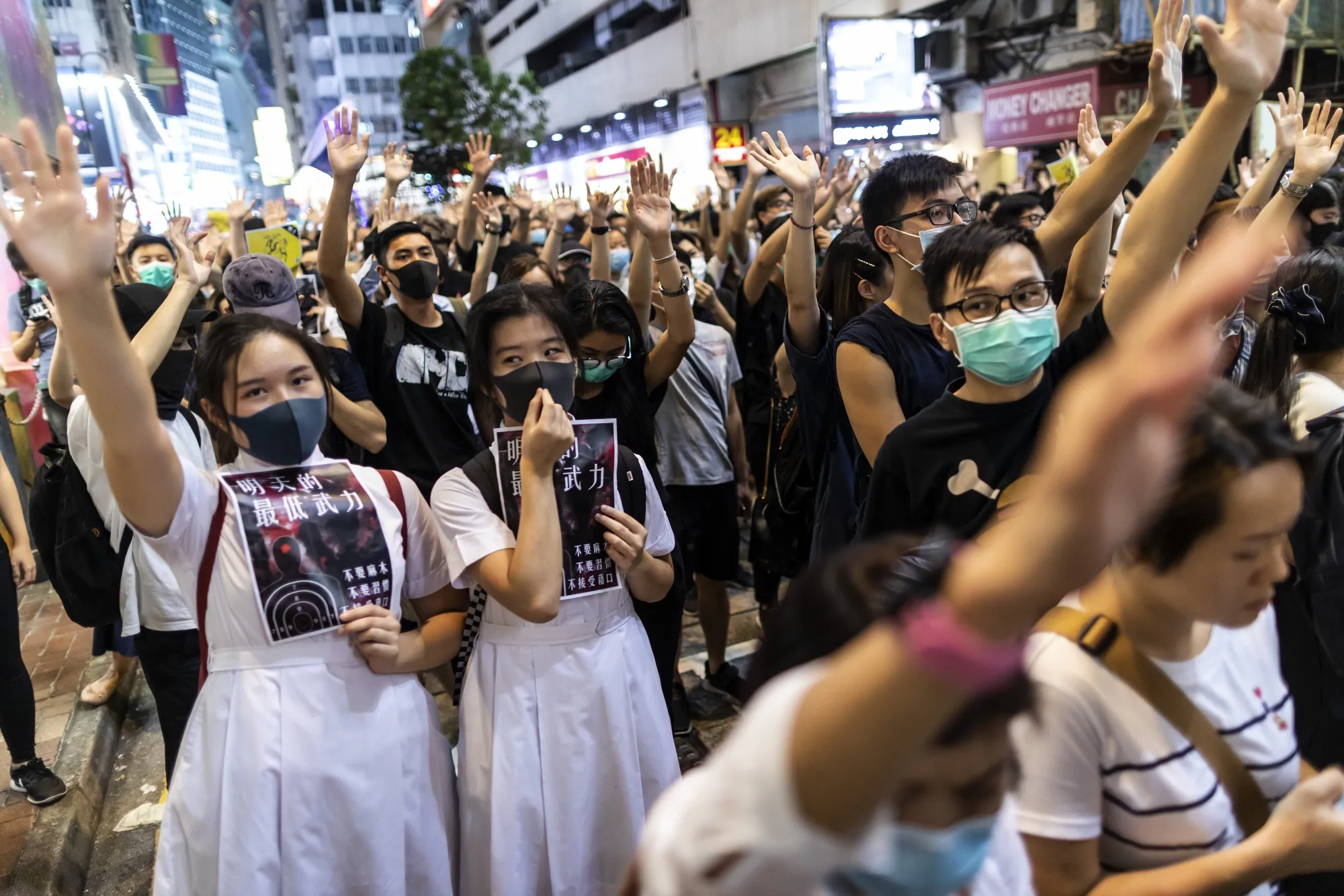 Demonstrators raise their hands up during a protest in the Causeway Bay district of Hong Kong on Oct. 2.