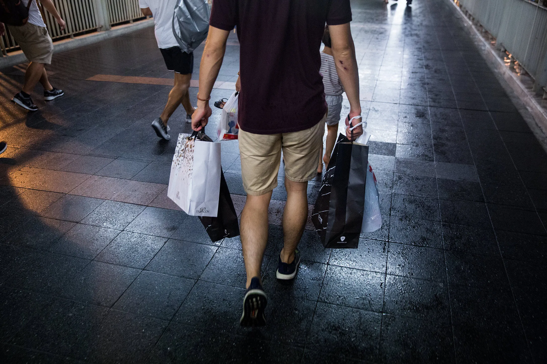 A shopper carries shopping bags in Bangkok, Thailand, on June 21, 2017.
