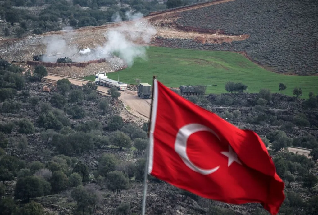 Turkish troops shell a YPG position.
