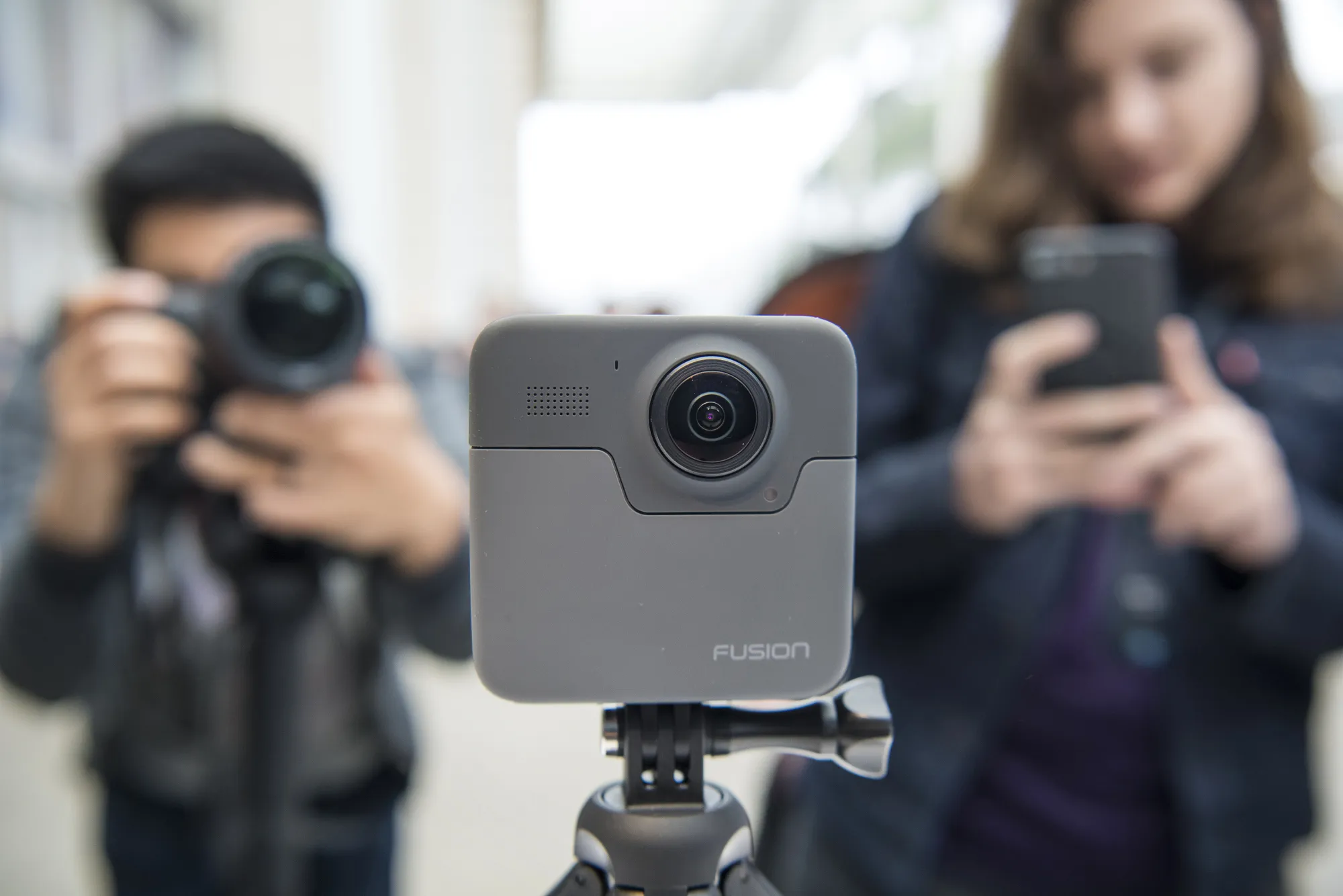 Attendees take photographs of the GoPro Inc. Fusion 360 camera during an event in San Francisco.
