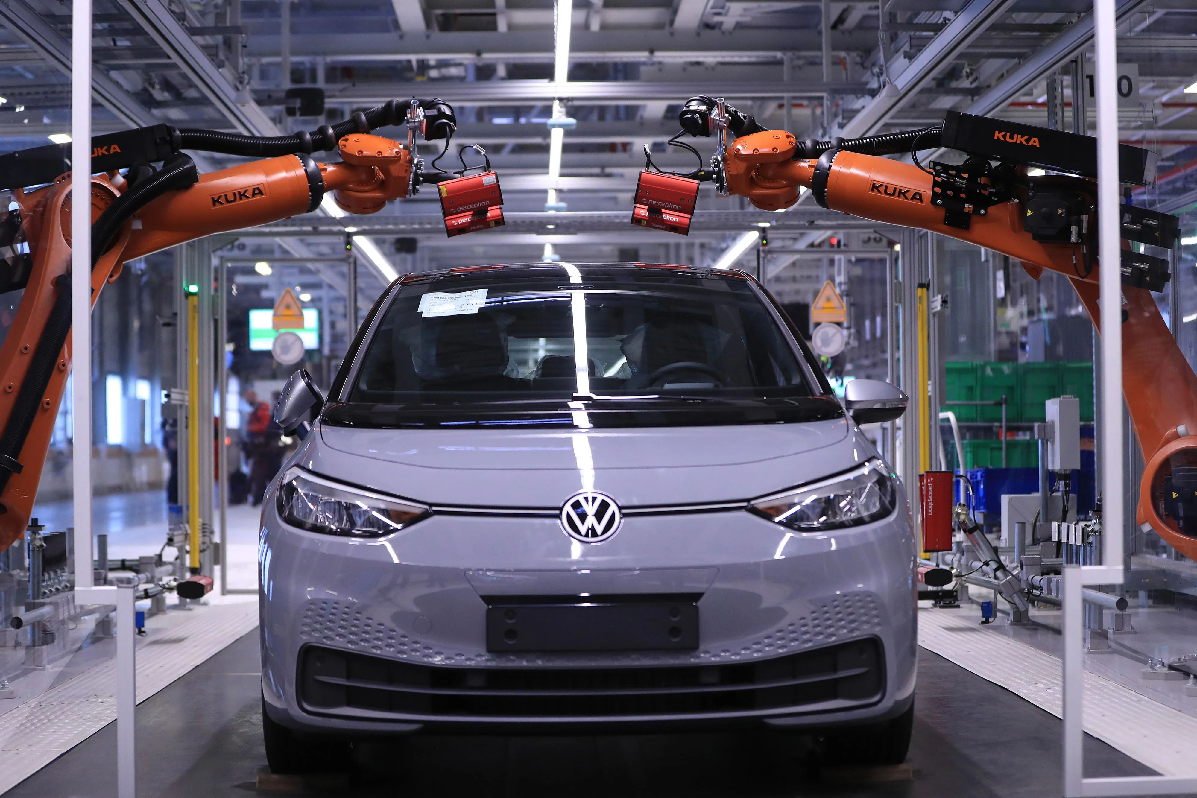 Robots scan a VW automobile at a factory in Zwickau.