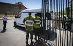 Members of Moroccan security forces stand guard as a vehicle transporting the suspects charged over the murder of two Scandinavian women hiking in Morocco, drives outside a court in Sale, near the capital Rabat on May 30, 2019.