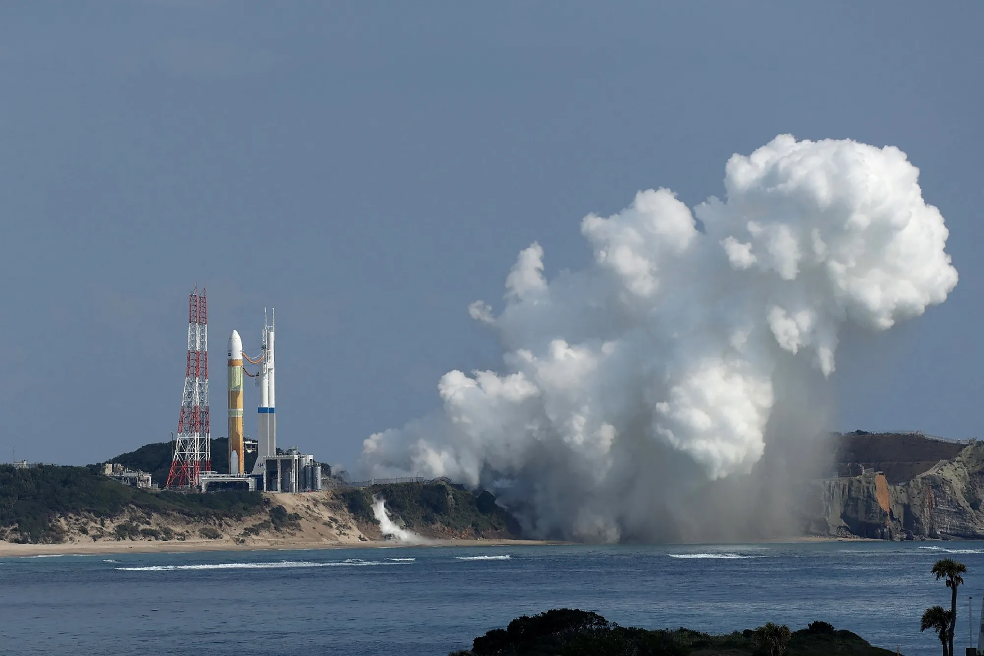 Smoke emerges from the main engines of the next-generation H3 rocket at Tanegashima Space Center,&nbsp;Japan, in February.