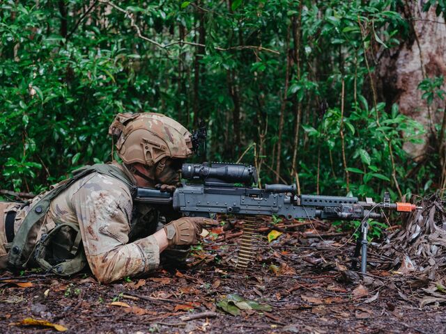 A soldier holding a weapon conducts watch during a training exercise at the Jungle Operations Training Center at Lightning Academy on Honolulu, Hawaii. 