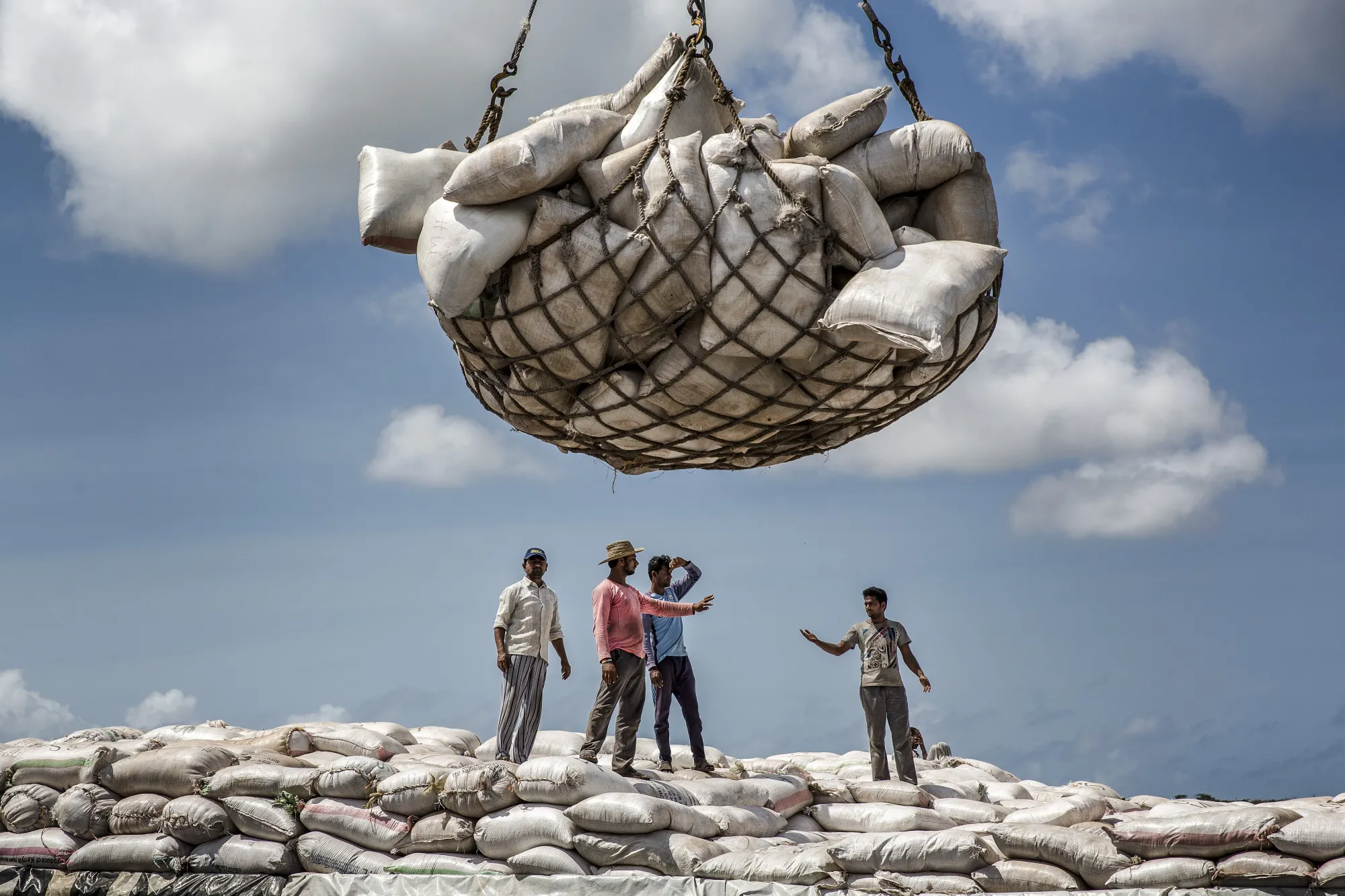 Dock workers&nbsp;load&nbsp;sacks onto a cargo ship at Mombasa port.
