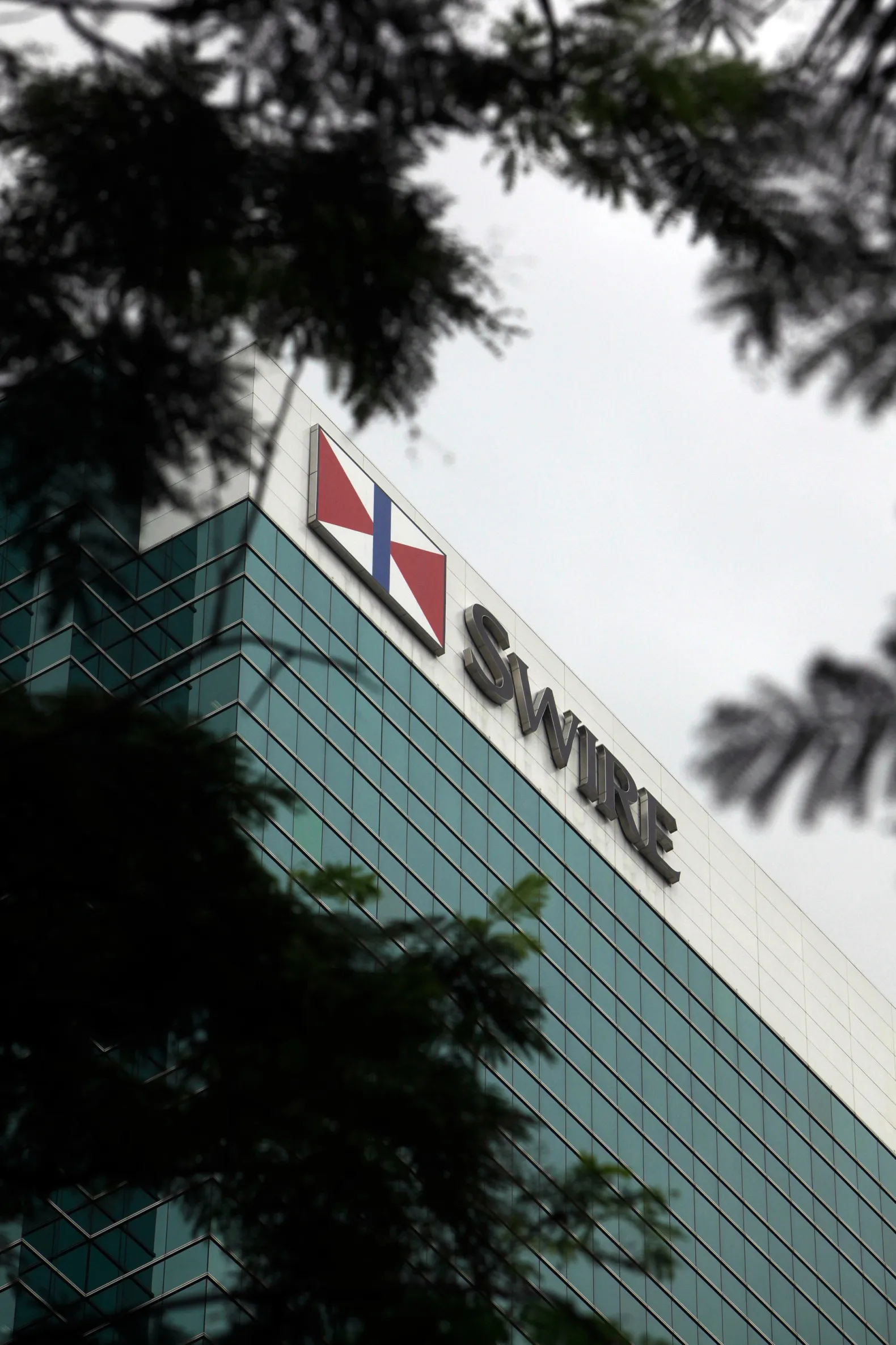 The Swire Pacific Ltd. logo adorns Two Pacific Place in Hong Kong, China, on Wednesday, Aug. 5, 2009. Swire Pacific is expected to announce interim results tomorrow.