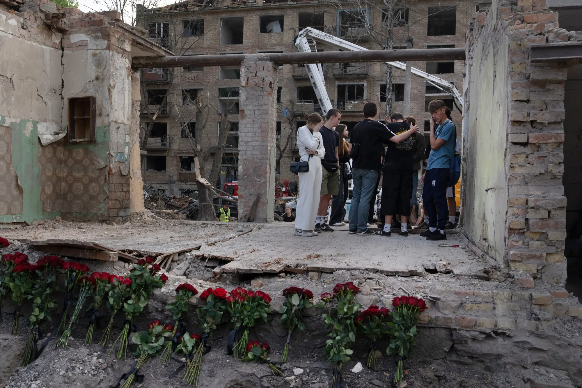 Mourners visit the site of a Russian strike in Kyiv on April 25.
