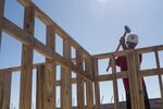 A worker hammers a piece of lumber to a wall frame on a home under construction at the M/I Homes Inc. Bougainvillea Place housing development in Ellenton, Florida.