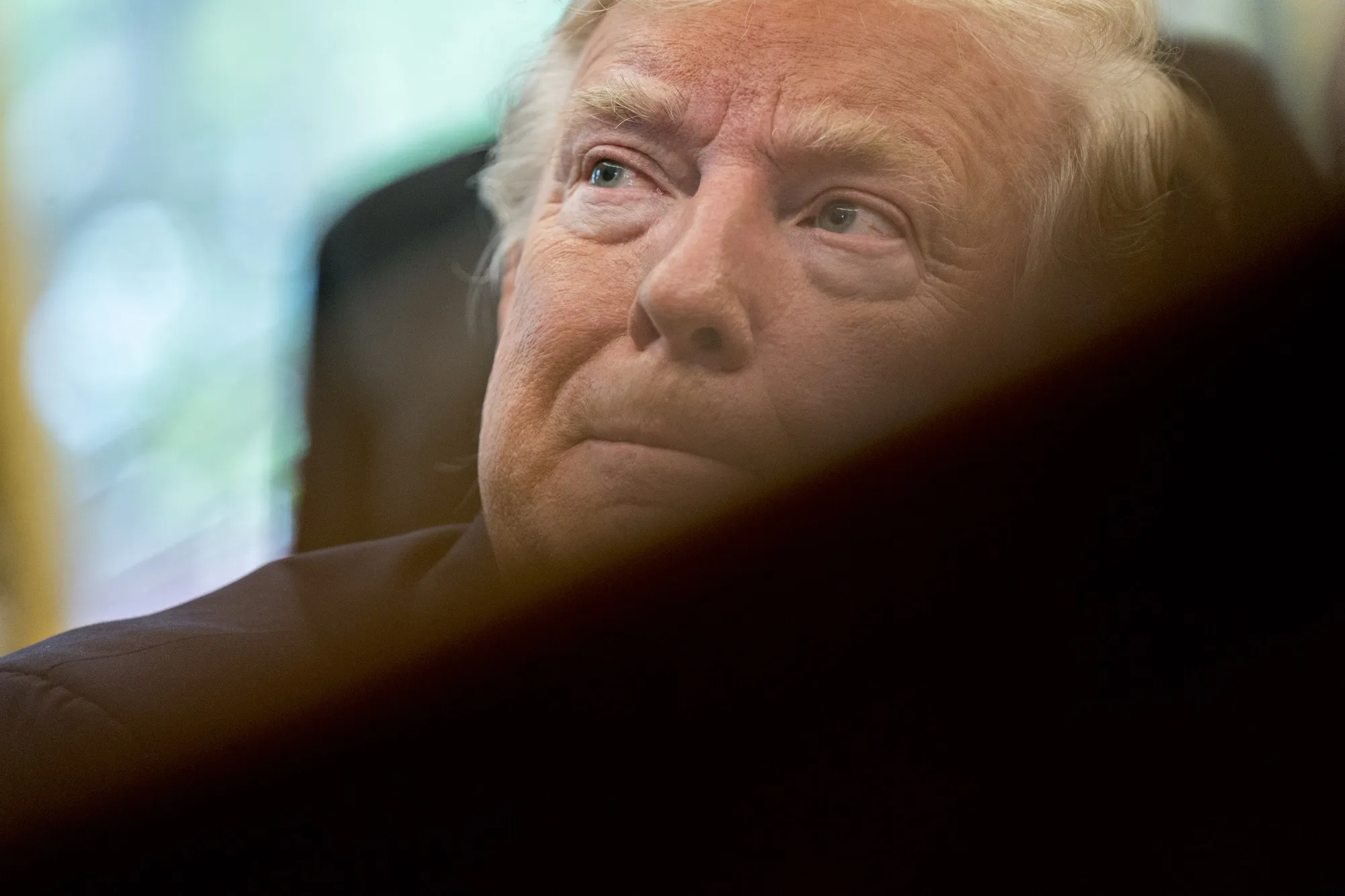 U.S. President Donald Trump listens during an event commemorating the 50th anniversary of the Apollo 11 moon landing in the Oval Office of the White House in Washington, D.C., U.S., on Friday, July 19, 2019. Trump welcomed former Apollo 11 astronauts to celebrate the 50th anniversary of the moon landing, as his administration continues to wrestle with the next step in U.S. space exploration.