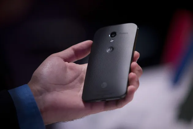 An attendee inspects Motorola Mobility’s Moto X phone during a launch event in New York on Aug. 1, 2013