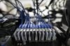 Cables connect to a Sapphire Technology Ltd. graphics processing unit (GPU) on a shelf inside the DMM Mining Farm, operated by DMM.com Co., in Kanazawa, Japan, on Tuesday, March 20, 2018. Japan is moving toward legalizing initial coin offerings, even as countries such as China and the U.S. restrict the fundraising technique because of their risks for investors. A government-backed study group laid out basic guidelines for further adoption of ICOs, according to a report published on April 5.