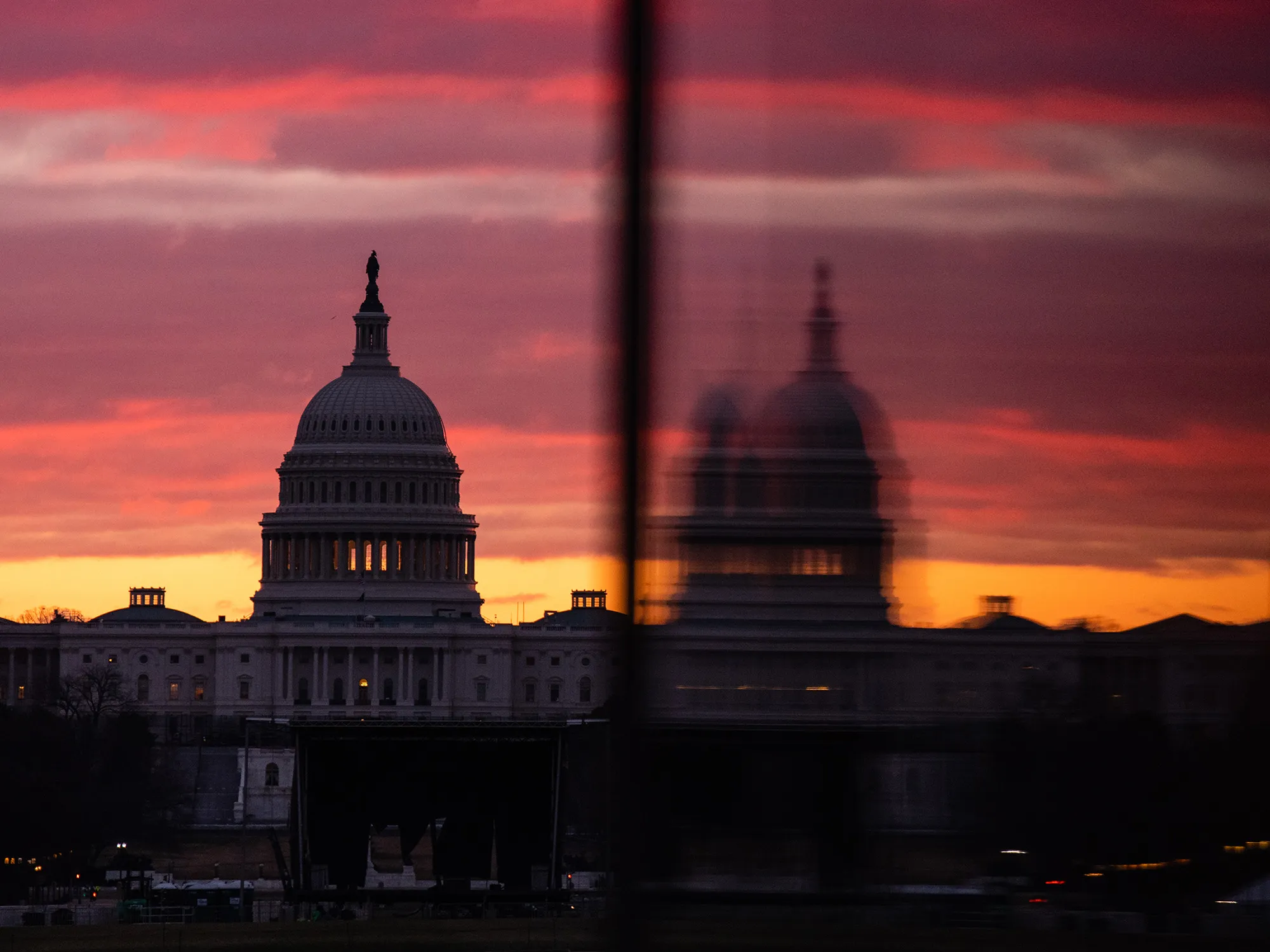 The U.S. Capitol is reflected in an entrance to the Washington Monument in Washington, D.C.