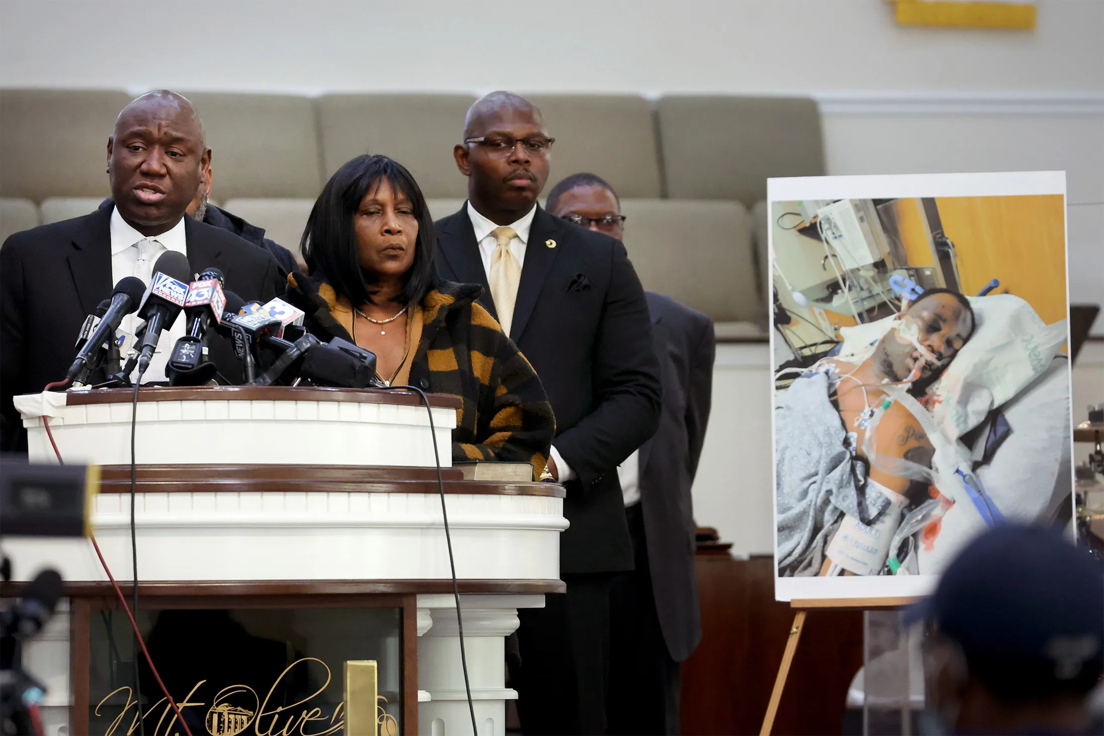 Flanked by Rodney Wells, center, and RowVaughn Wells, the stepfather and mother of Tyre Nichols, civil rights attorney Ben Crump speaks next to a photo of Tyre Nichols during a press conference in Memphis, Tennessee, on Jan. 27.