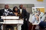 Flanked by Rodney Wells, center, and RowVaughn Wells, the stepfather and mother of Tyre Nichols, civil rights attorney Ben Crump speaks next to a photo of Tyre Nichols during a press conference in Memphis, Tennessee, on Jan. 27.