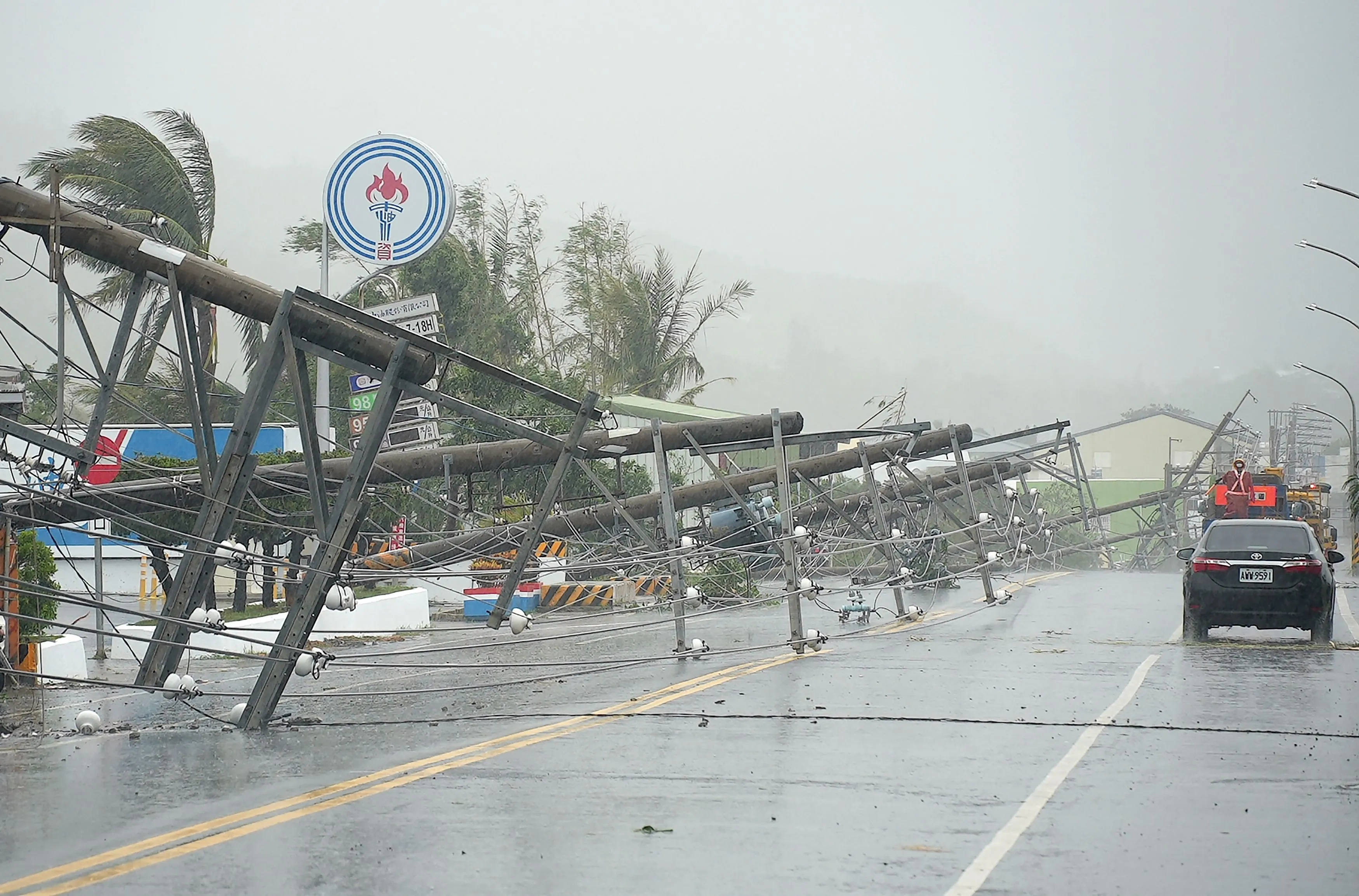 A car passes by power lines downed by Typhoon Koinu in Pingtung, Taiwan&nbsp;on October 5.