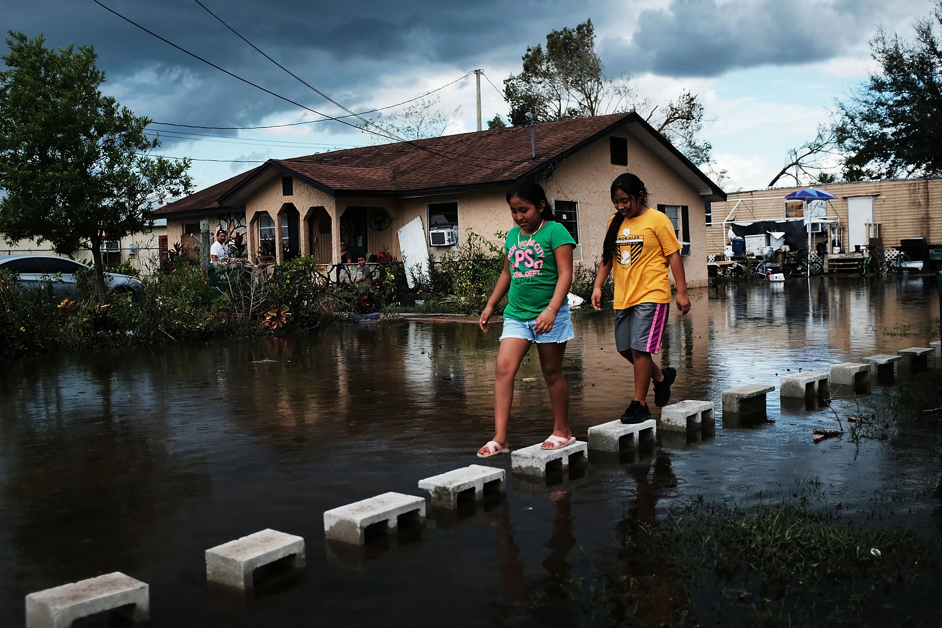Children walk through flooded streets in the town of Immokalee, Florida, which was especially hard hit by Hurricane Irma.
