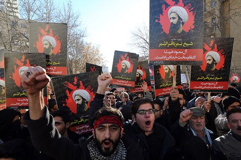 Protesters hold portraits of prominent Shiite Muslim cleric Nimr al-Nimr