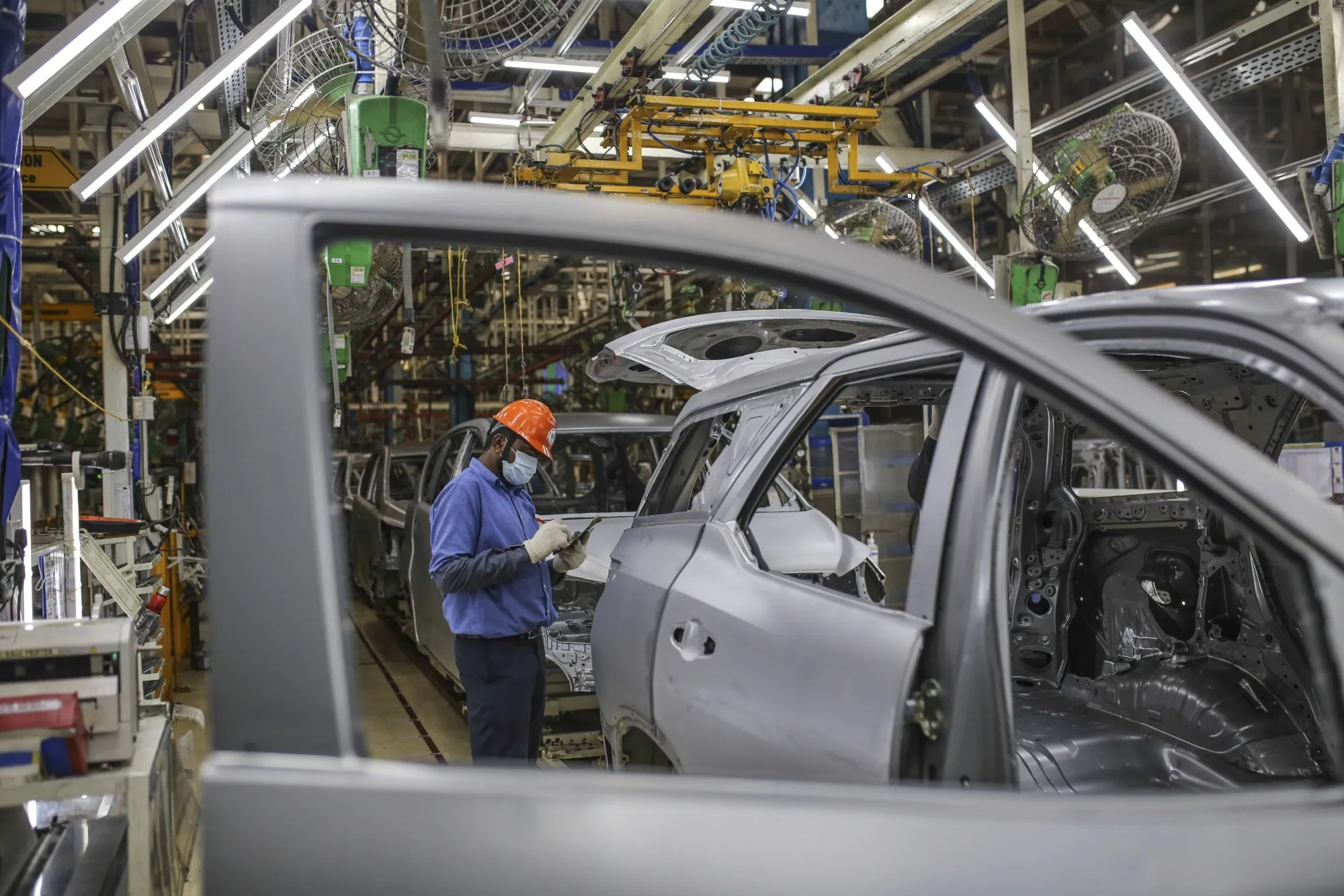 A worker on&nbsp;an inspection line at the Toyota Kirloskar Motor Ltd. plant in Bidadi, Karnataka, India.