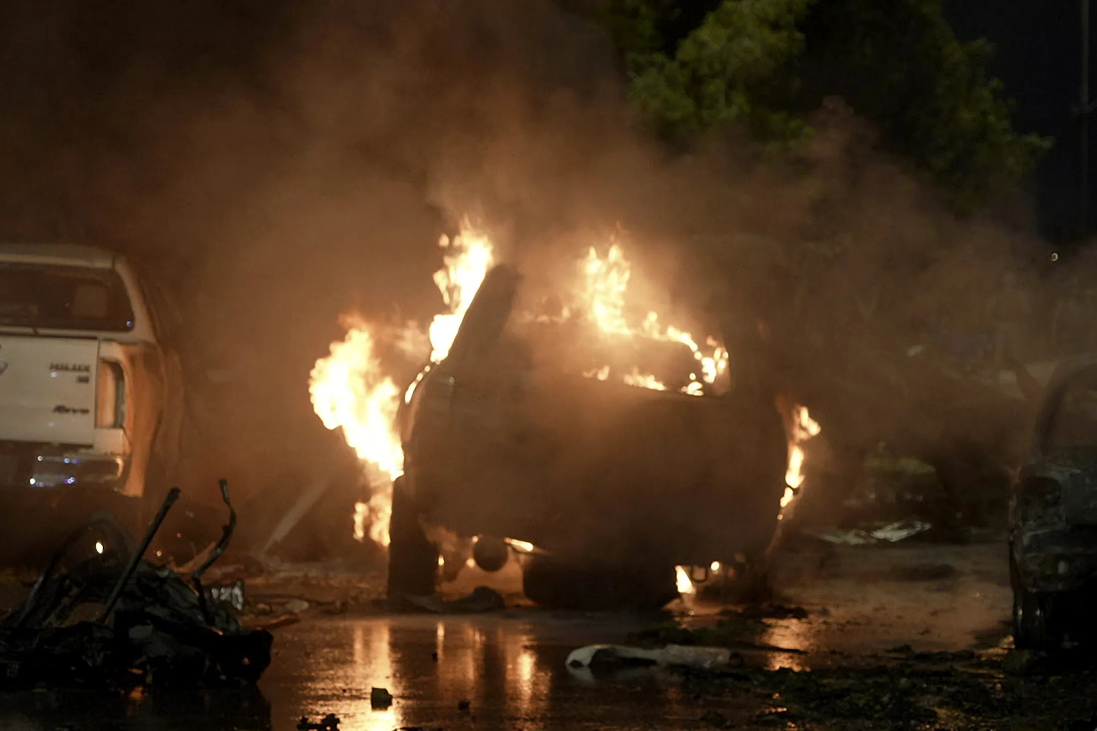 A vehicle on fire at the site of an explosion outside the Karachi airport, Pakistan, Sunday, Oct. 6, 2024.