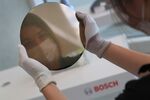 A worker holds a silicon wafer at Robert Bosch’s semiconductor fabrication plant in Dresden, Germany, in May.
