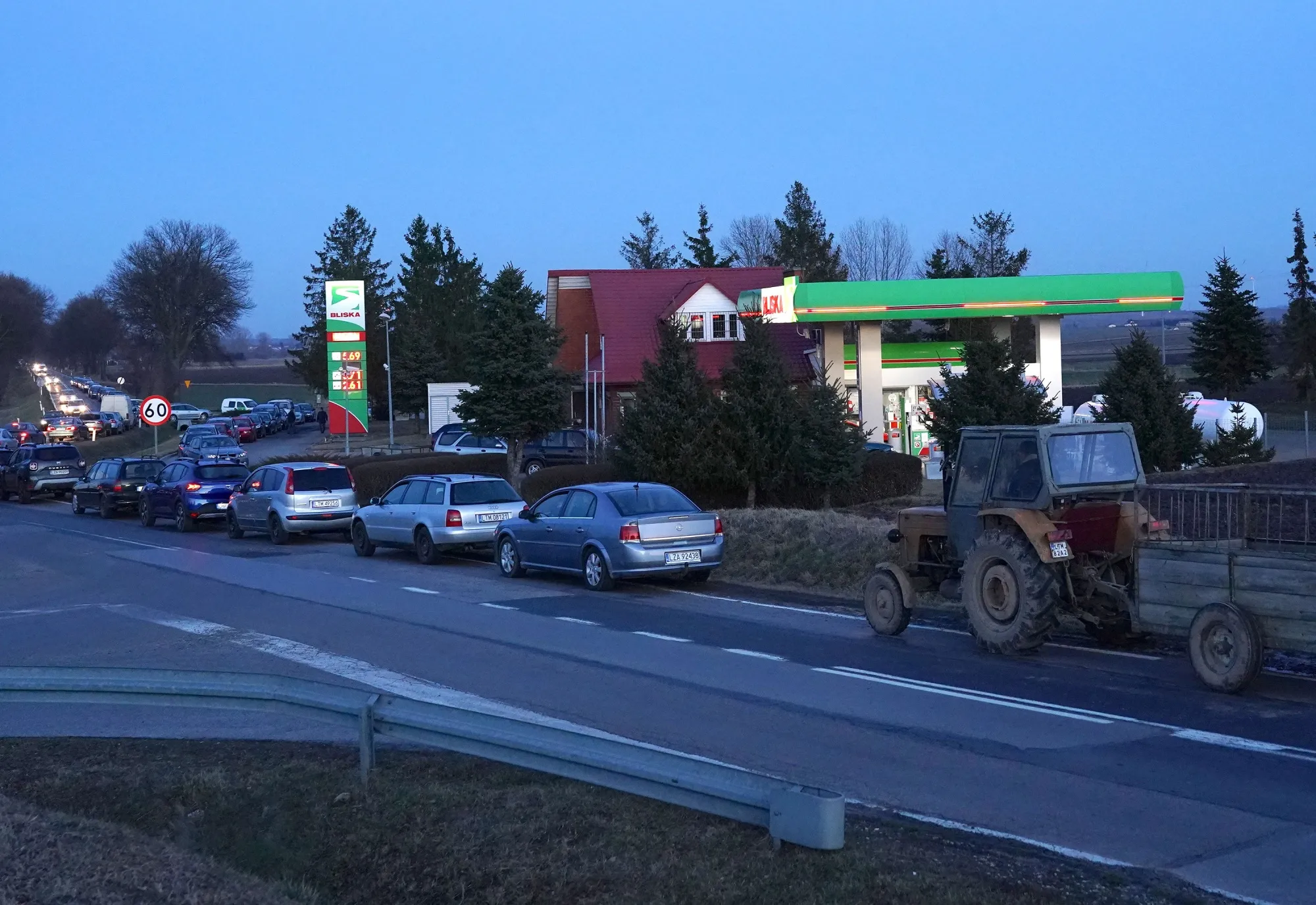 People queue at a petrol station near the Poland-Ukrainian border at Kaliwy near Tyszowce, Poland, on Feb. 24.
