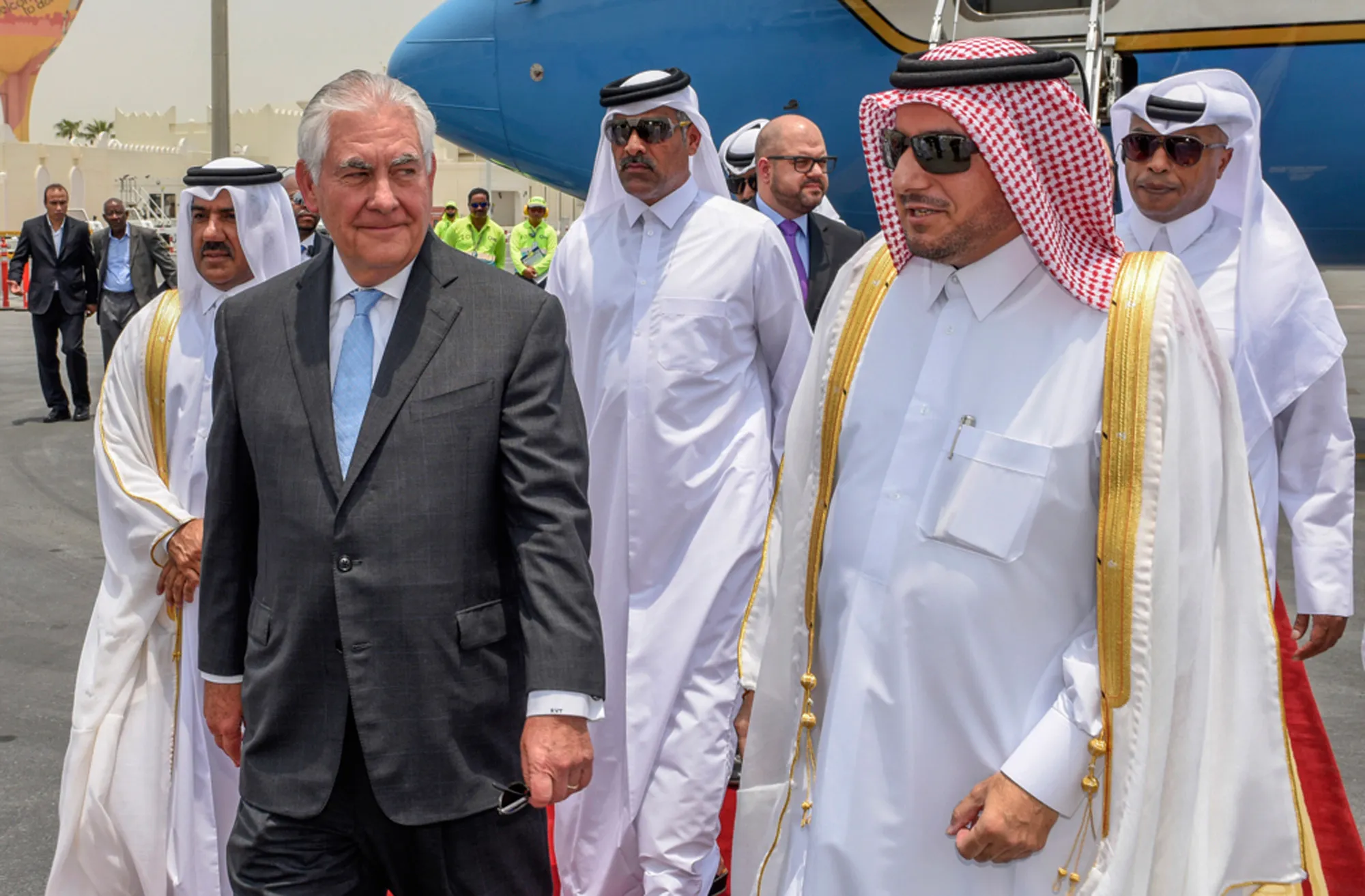 Qatari officials greet Tillerson as he arrives in Doha on July 11.&nbsp;
