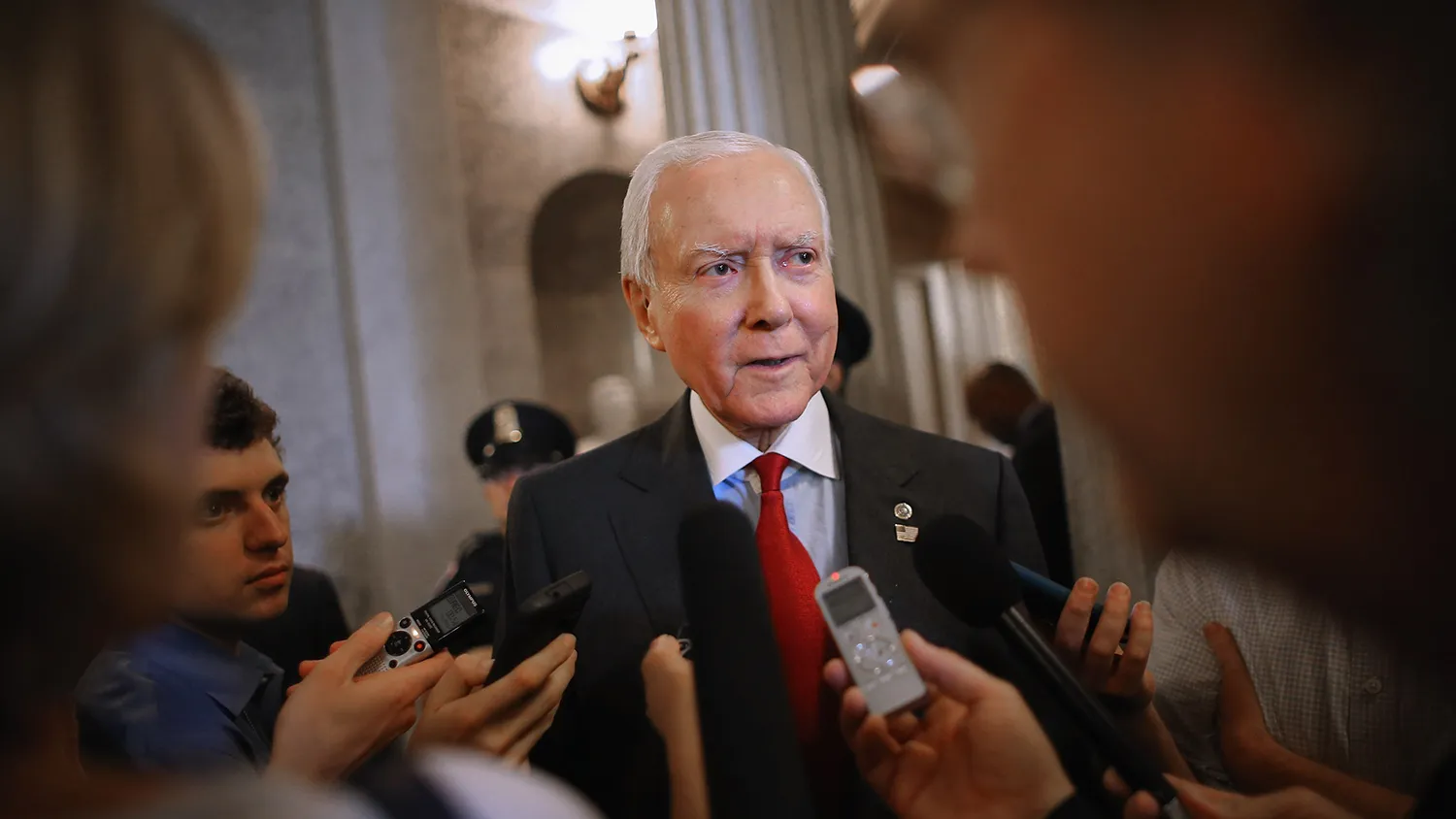 Sen. Orrin Hatch (R-UT) (C) talks with reporters after leaving the Senate floor at the U.S. Capitol May 18, 2015 in Washington, DC.
