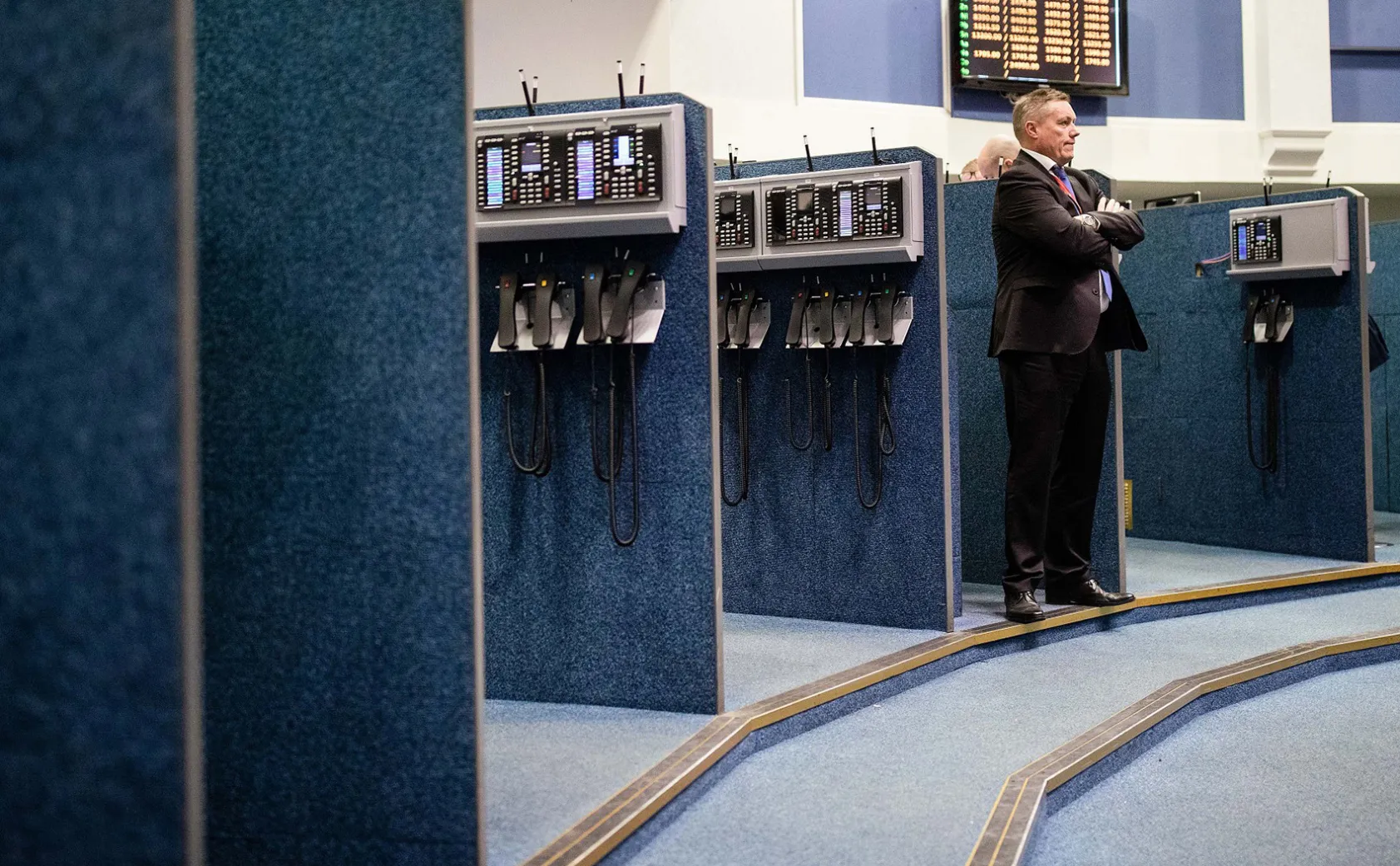 A trader looks out onto the trading floor of the open outcry pit at the London Metal Exchange, on Jan. 14
