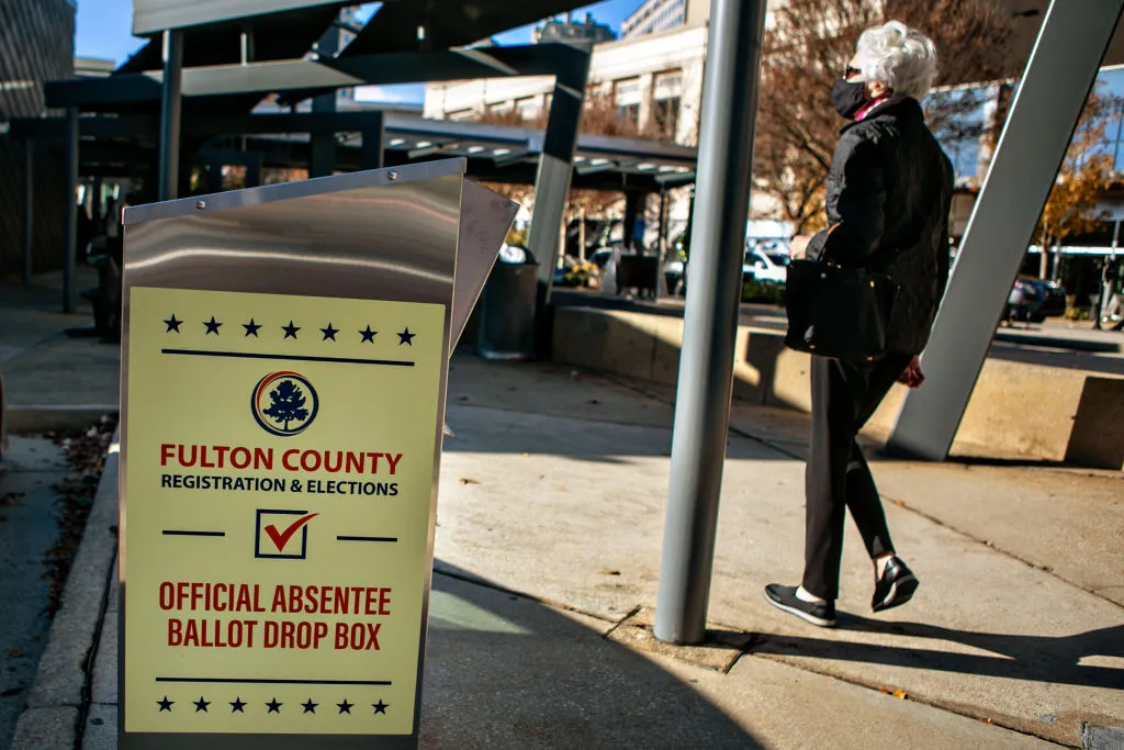 A voter arrives at the Buckhead library in Atlanta&nbsp;for the Georgia Senate runoff election in December 2020. The number of ballot drop boxes for early voting was substantially cut back in the Election Integrity Act of 2021.&nbsp;