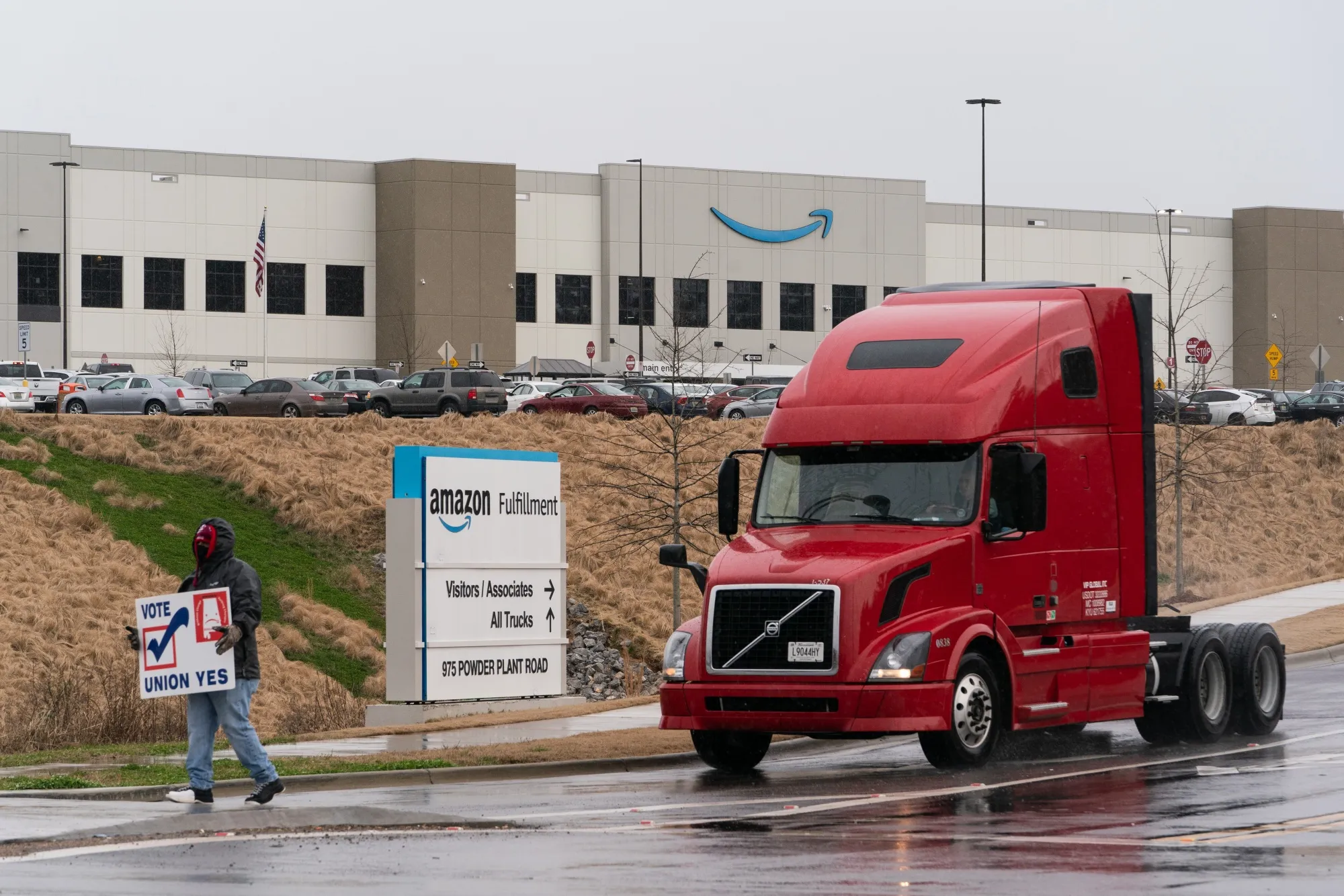 A demonstrator holds a sign during a RWDSU protest outside the Amazon Fulfillment Center in Bessemer, Alabama.