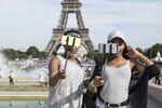Tourists take&nbsp;selfies&nbsp;in front of the Eiffel Tower&nbsp;in Paris, France.