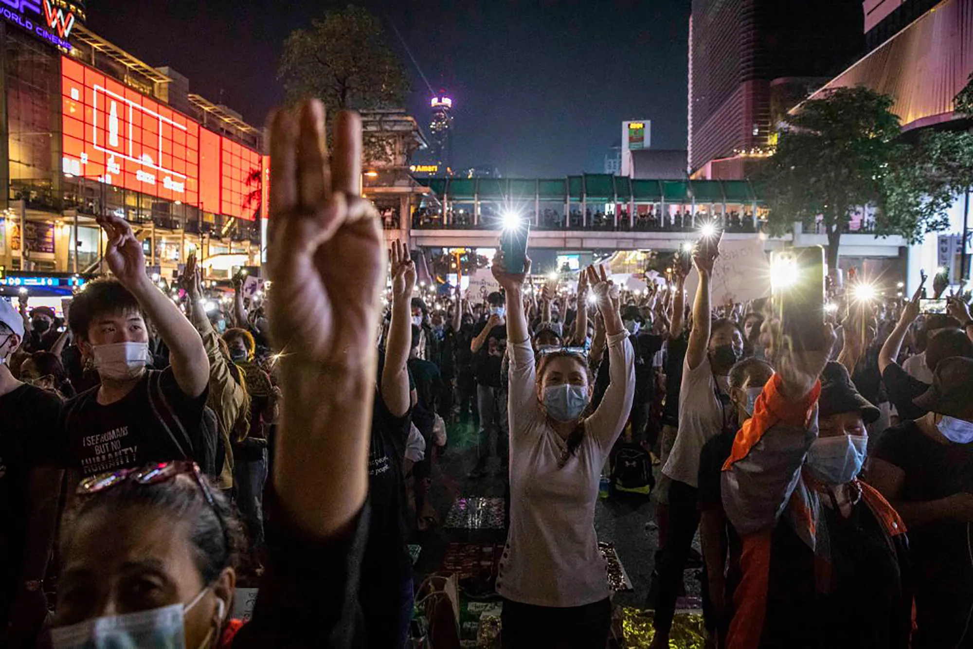 Thai pro-democracy protesters hold up a three finger salute during a rally in Bangkok&nbsp;on March 24, 2021.