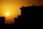 The sun sets beyond crude oil storage tanks at the Juaymah tank farm at Saudi Aramco's Ras Tanura oil refinery and oil terminal in Ras Tanura, Saudi Arabia, on Monday, Oct. 1, 2018. Saudi Aramco aims to become a global refiner and chemical maker, seeking to profit from parts of the oil industry where demand is growing the fastest while also underpinning the kingdom’s economic diversification. Photographer: Simon Dawson