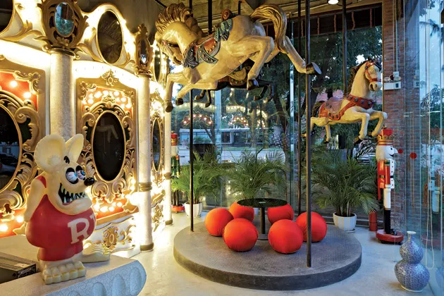 Carousel horses trot throughout the office. One conceals an overhead projector in its head