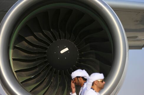 Visitors pass the engine of an Airbus A380-800 aircraft, operated by Etihad Airways.