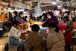 People dine at a food stall in Gwangjang Market in Seoul earlier in March.&nbsp;