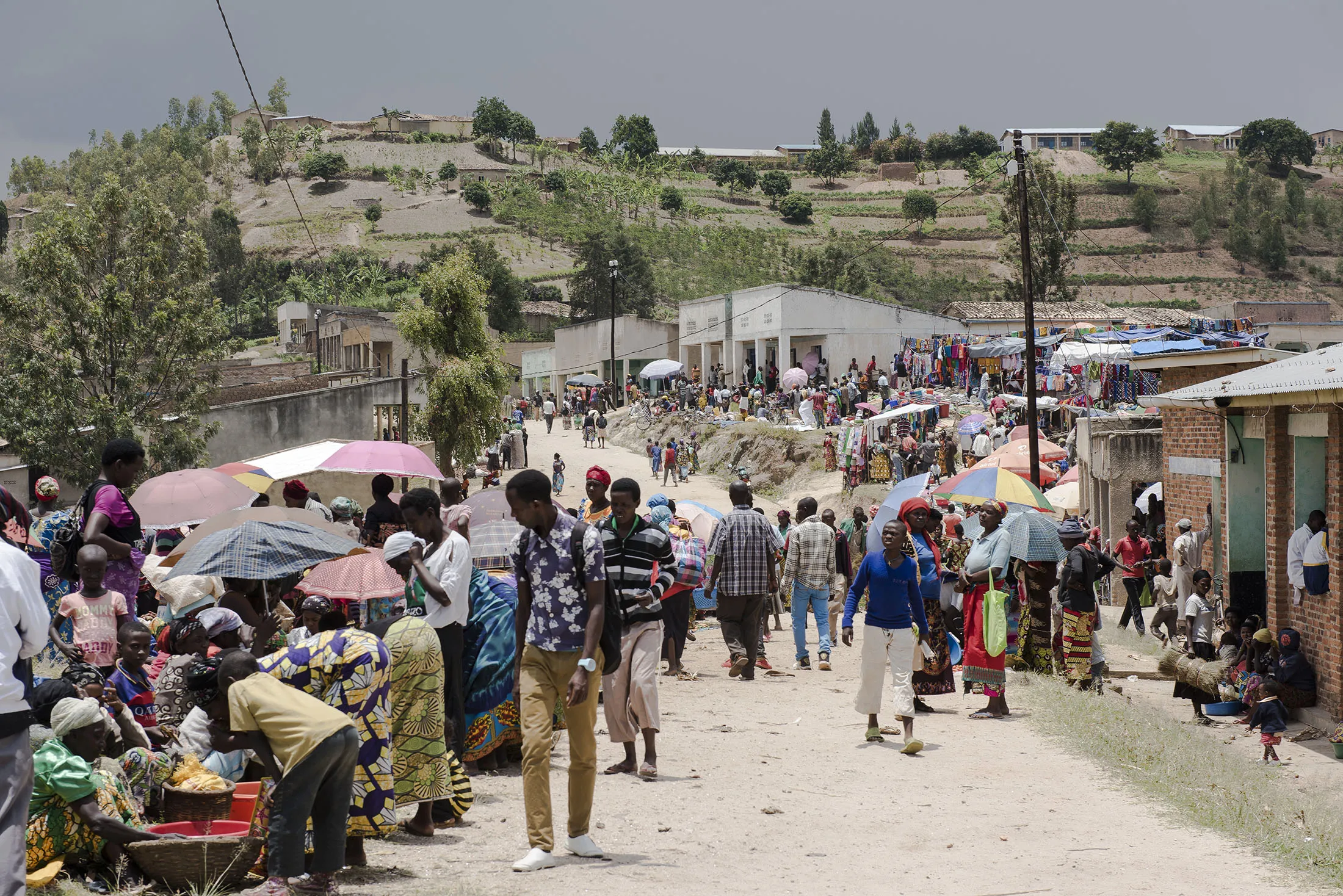 People walk through a market&nbsp;in&nbsp;Kayumbu, Rwanda.