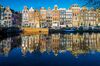 Amsterdam, Netherlands, Europe. Traditional old buildings reflected in the canal.