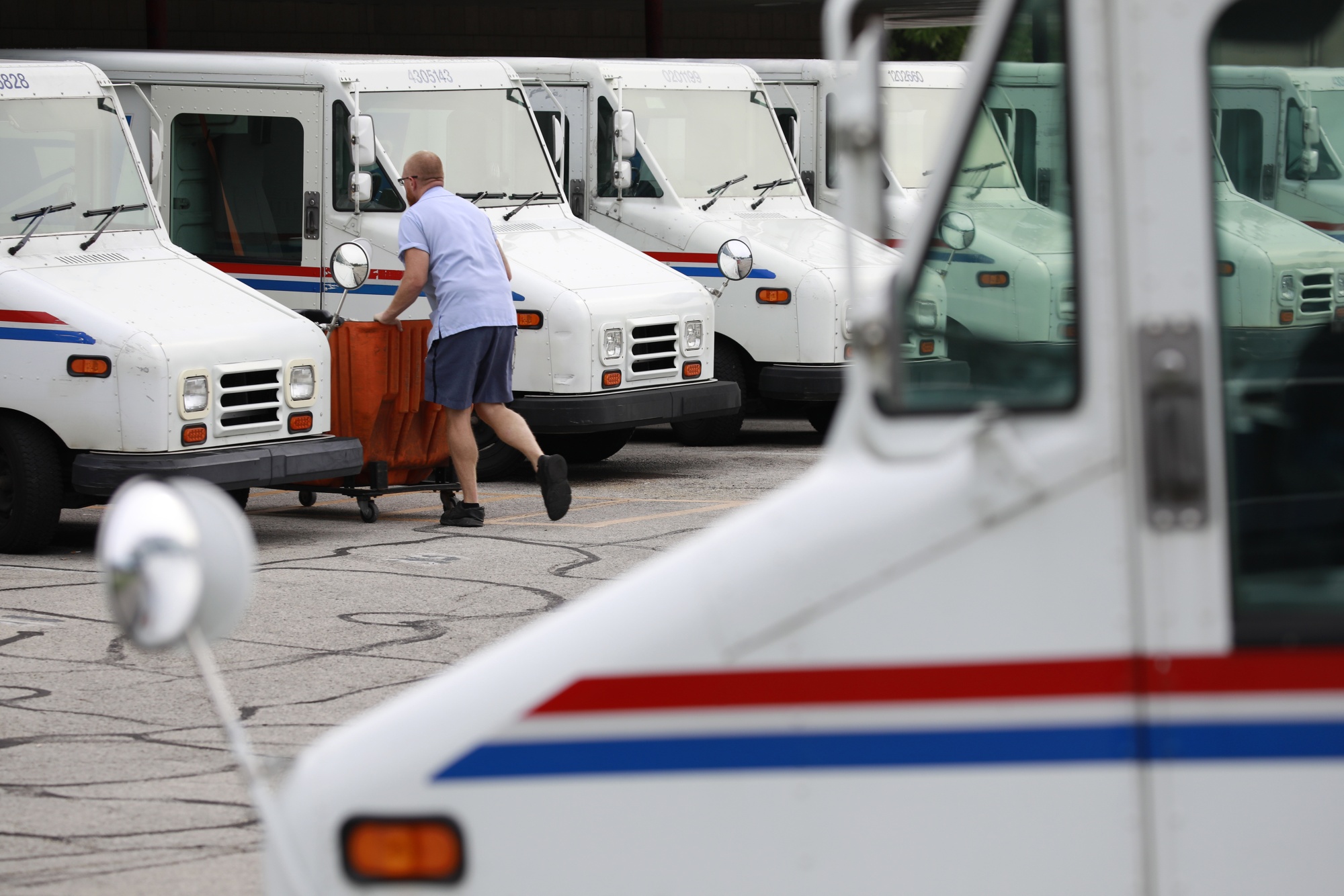 A USPS&nbsp;employee loads a mail delivery vehicle at a post office in Louisville, Kentucky.