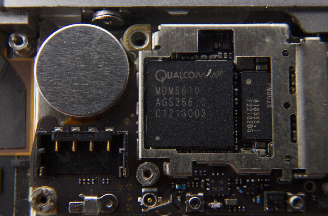 A Qualcomm Inc. baseband processor sits inside a smartphone sold as an Apple Inc.