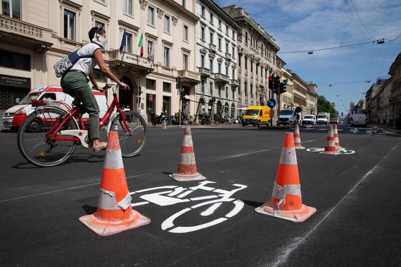 A cyclist passes a newly-marked cycle lane in Milan.