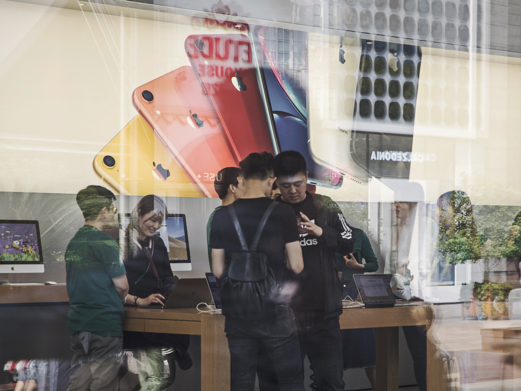 Customers browse products inside an Apple Inc. store in Shanghai.