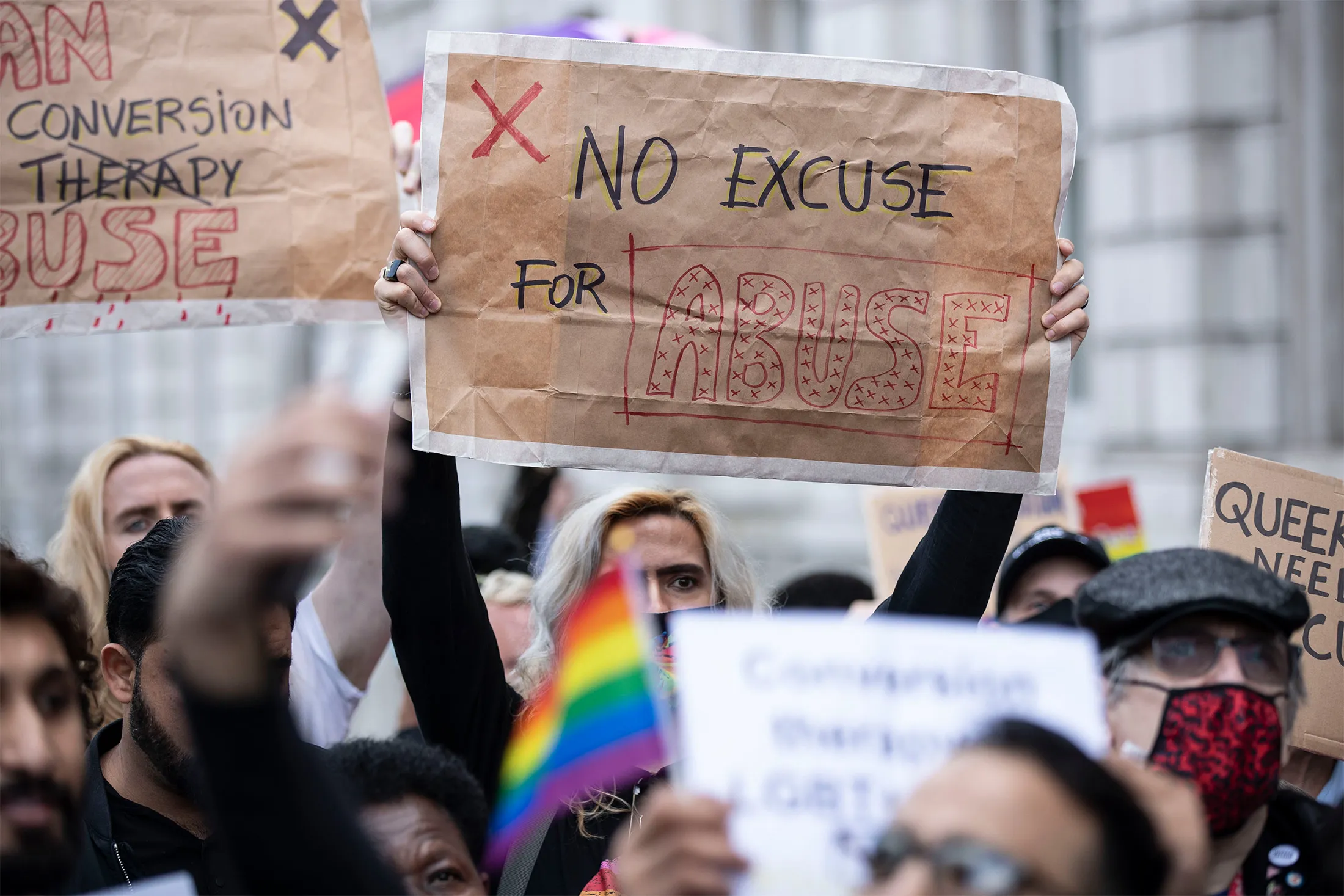 Protesters hold&nbsp;signs during the demonstration against the use of conversion therapy outside a U.K. Cabinet office in London in June 2021.