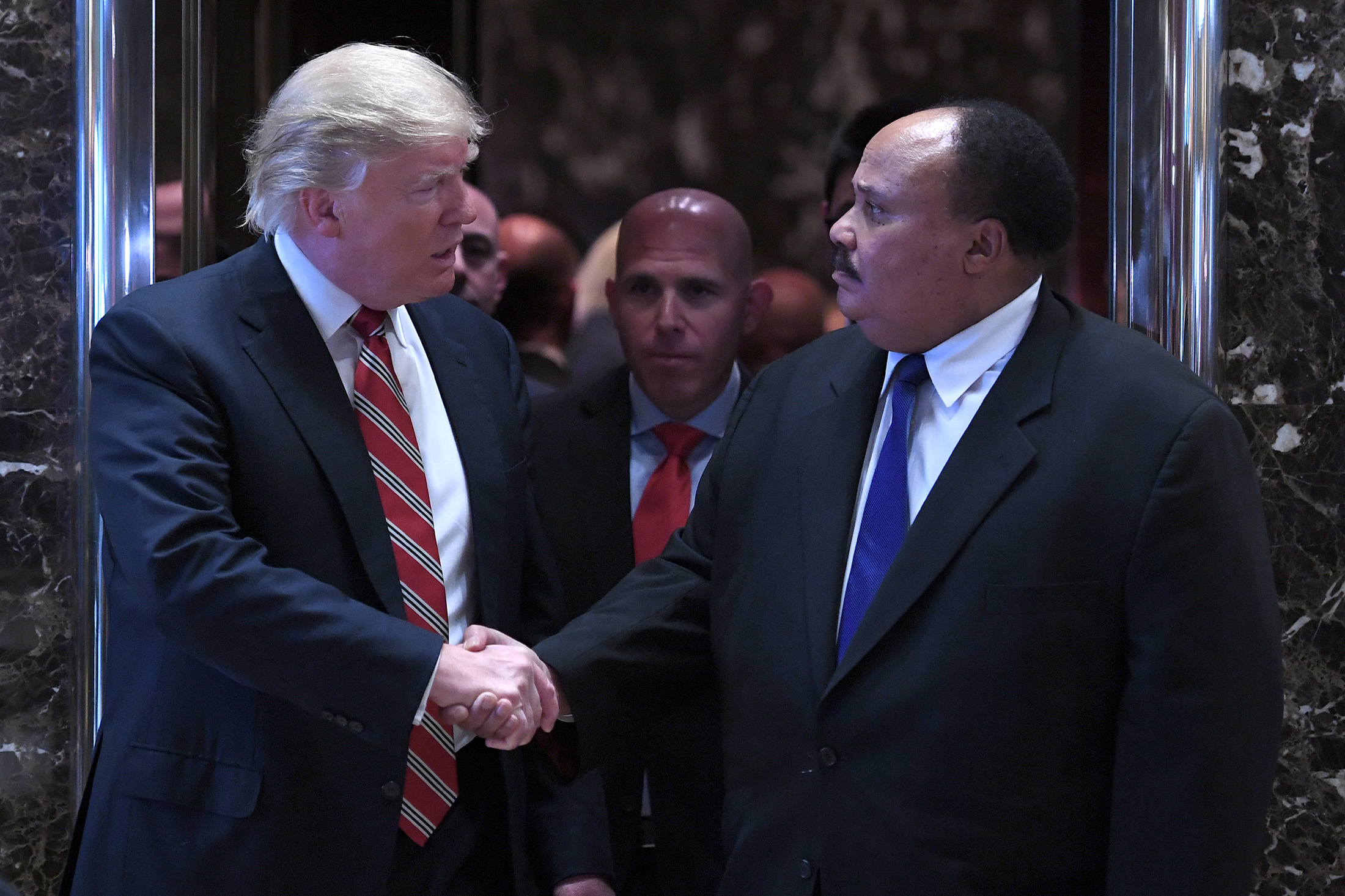 Trump shakes hands with Martin Luther King III.

