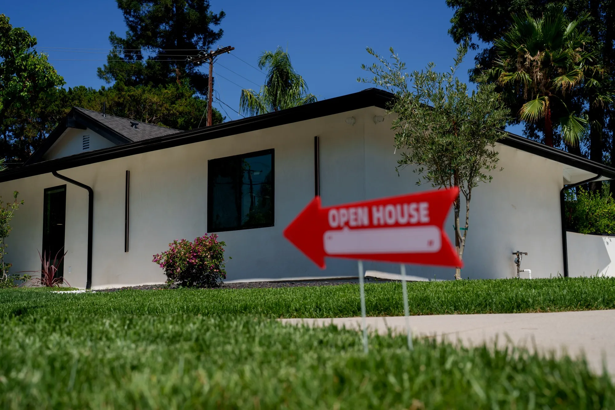 An “Open House” sign in front of a home for sale in the Woodland Hills neighborhood of Los Angeles, California.